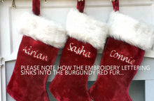 CHRISTMAS STOCKINGS This luxurious plush 21'' Christmas stocking is a deep burgundy color with faux fox fur trim.