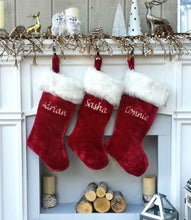 CHRISTMAS STOCKINGS This luxurious plush 21'' Christmas stocking is a deep burgundy color with faux fox fur trim.
